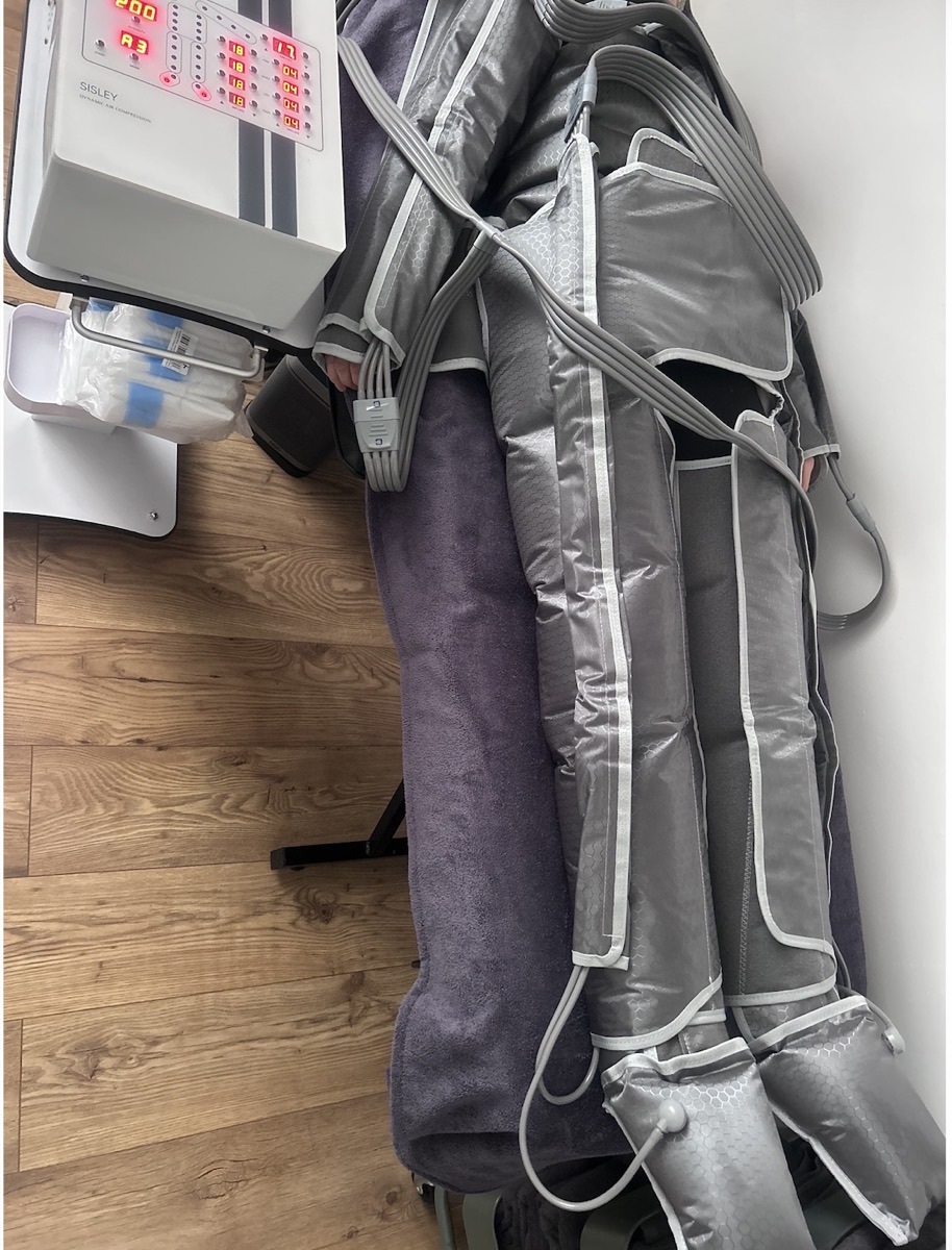 Client wearing a full-body sequential compression garment during pressotherapy at Wellness by Mariana in Southampton